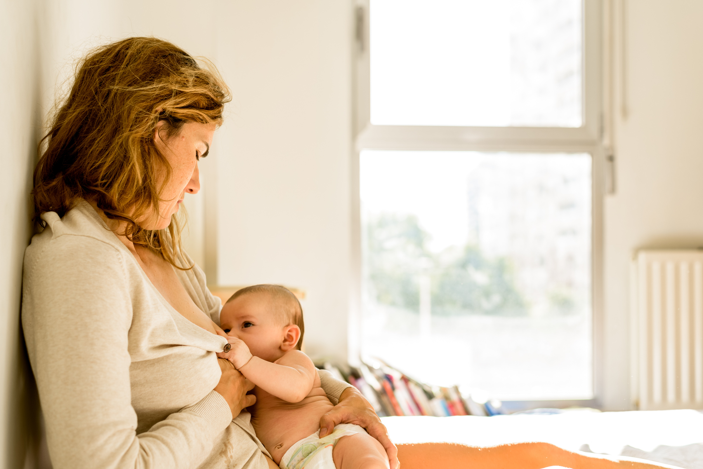 Mother Breastfeeding Baby at Home